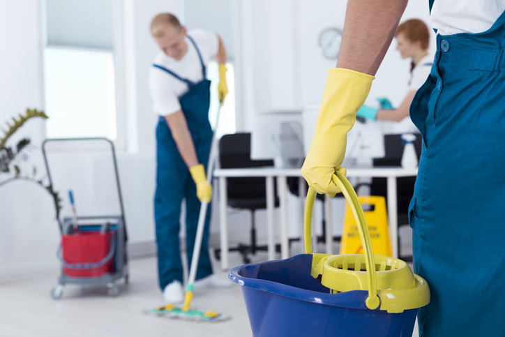 Person holding a mop pail stock photo