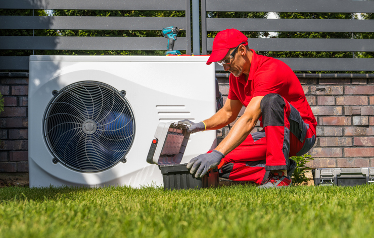 professional heat pumps technician installing new device