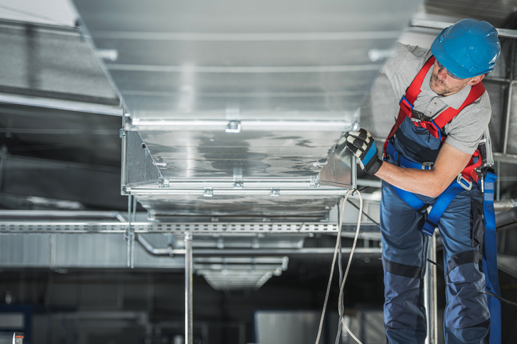 Warehouse Heating and Cooling System Installation by Professional Caucasian Technician