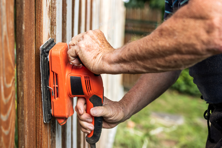 Close-up sander in male hands