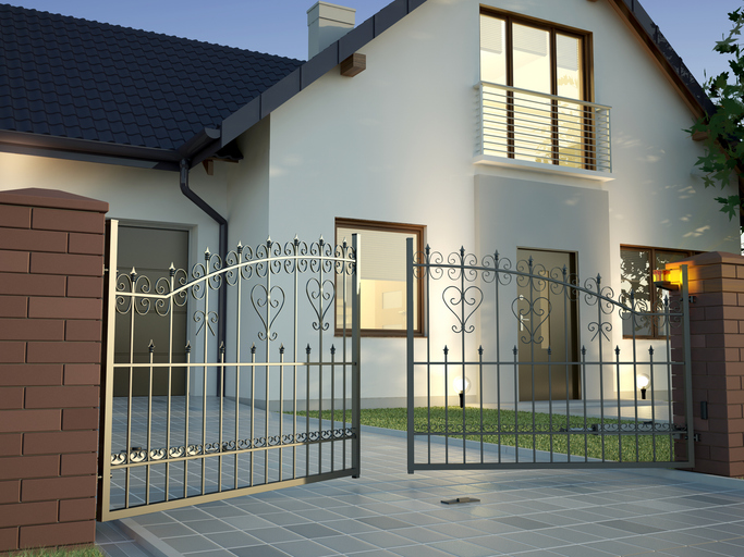 Classic Iron Gate and house stock photo