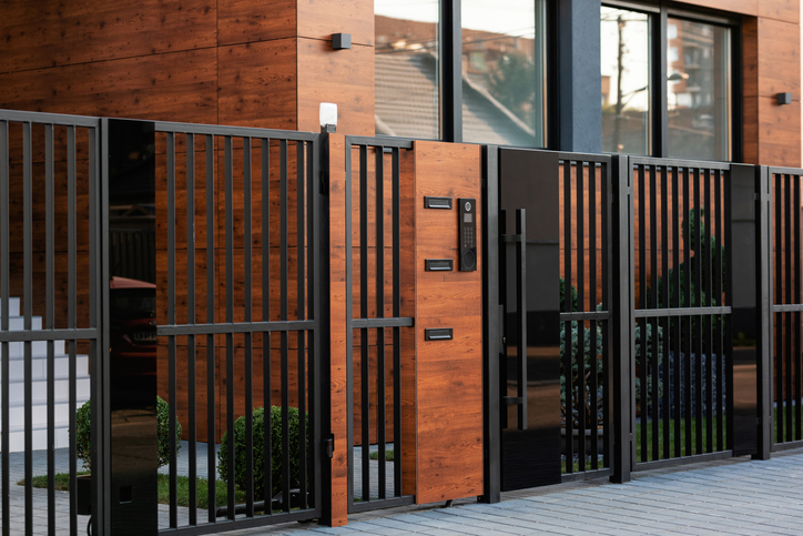 Intercom on safety gate in front of residential building.