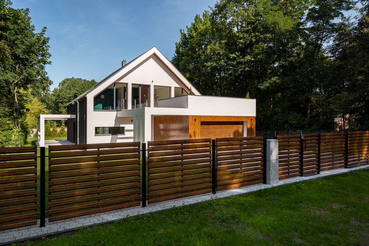 Spacious white house with wooden decoration on garage and wood style fence material comparison