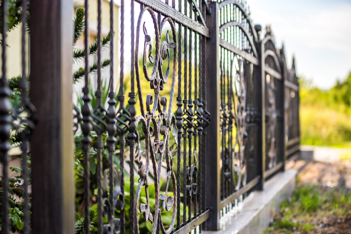 DIY vs. professional fence installation Wrought Iron Fence stock photo